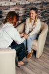 Professional psychological assistance. Psychologist comforting his patient. Woman psychologist talking to patient. Psychologist consulting and psychological therapy session concept.