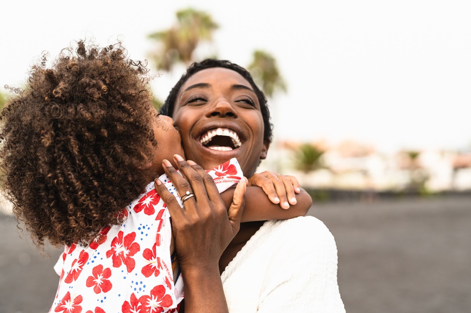 Two African American female friends hugging