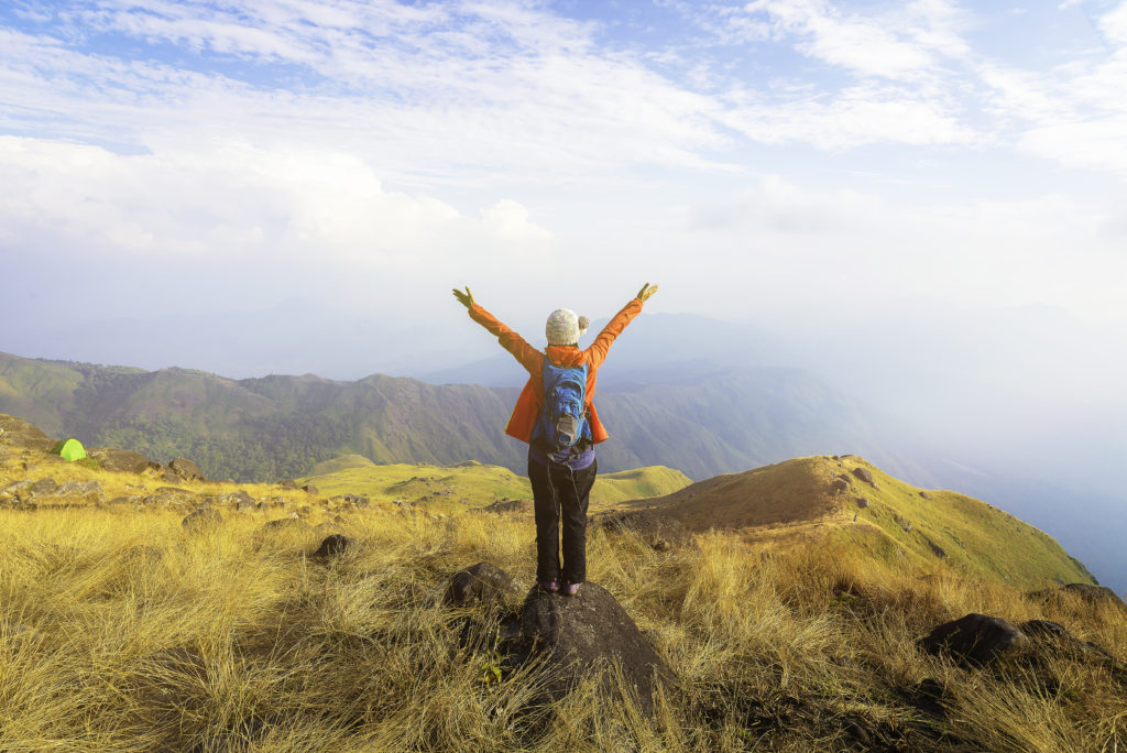 Hiker asian woman happy feeling freedom good and strong weight victorious facing on the natural mountain. Travel Concept