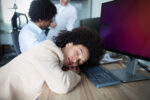 Overworked and tired businesswoman sleeping at work in her office