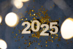 2025 new year wooden numbers with golden stars and bokeh