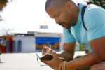 Young man journaling while outside