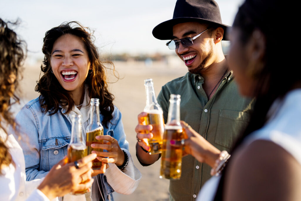 Group of young adults drinking alcohol together representing drinking culture